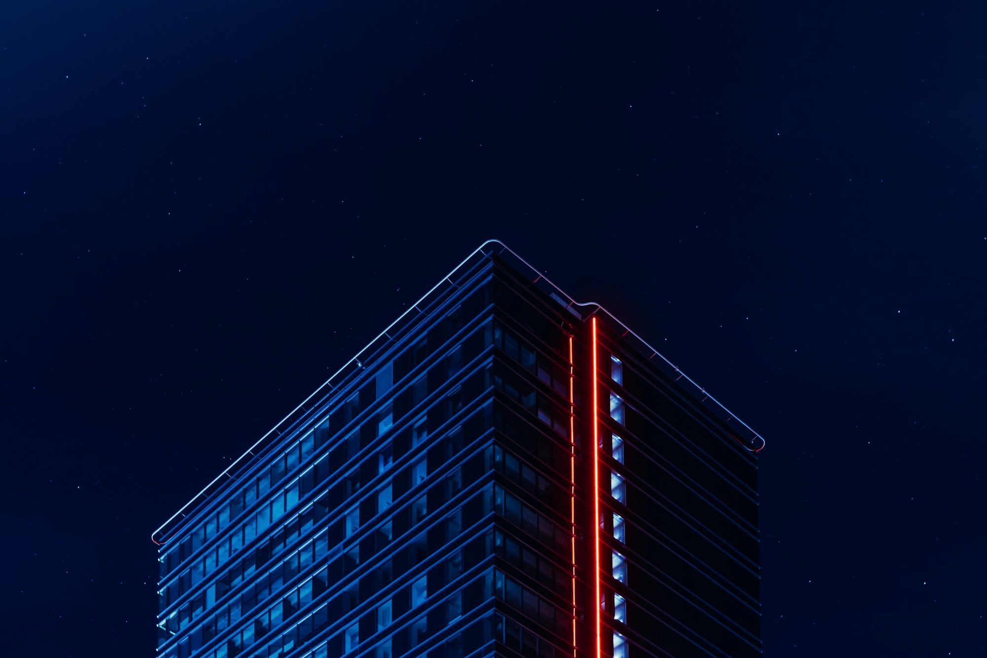 A glass office tower at night