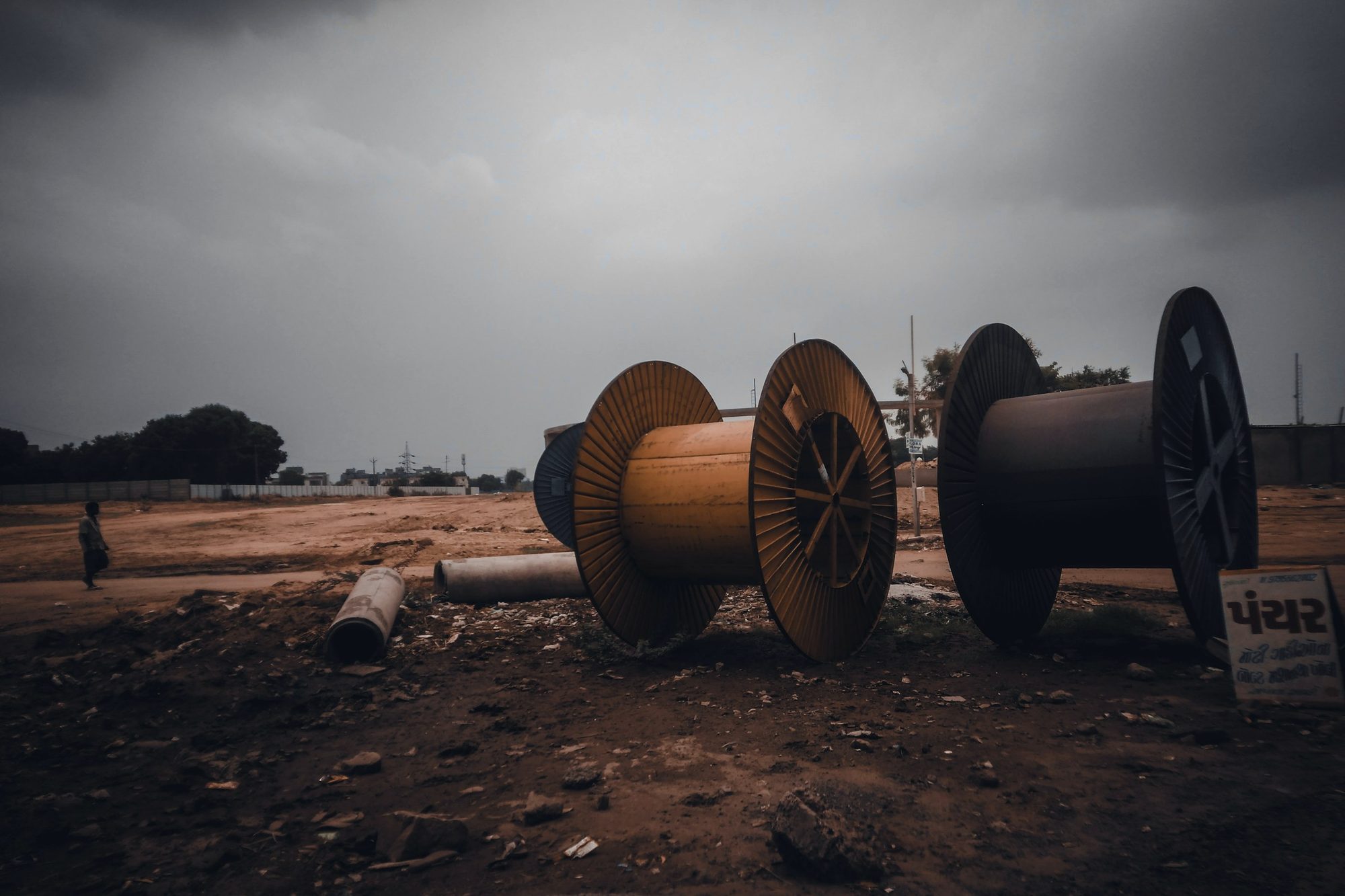 Cable spools on open ground at dusk