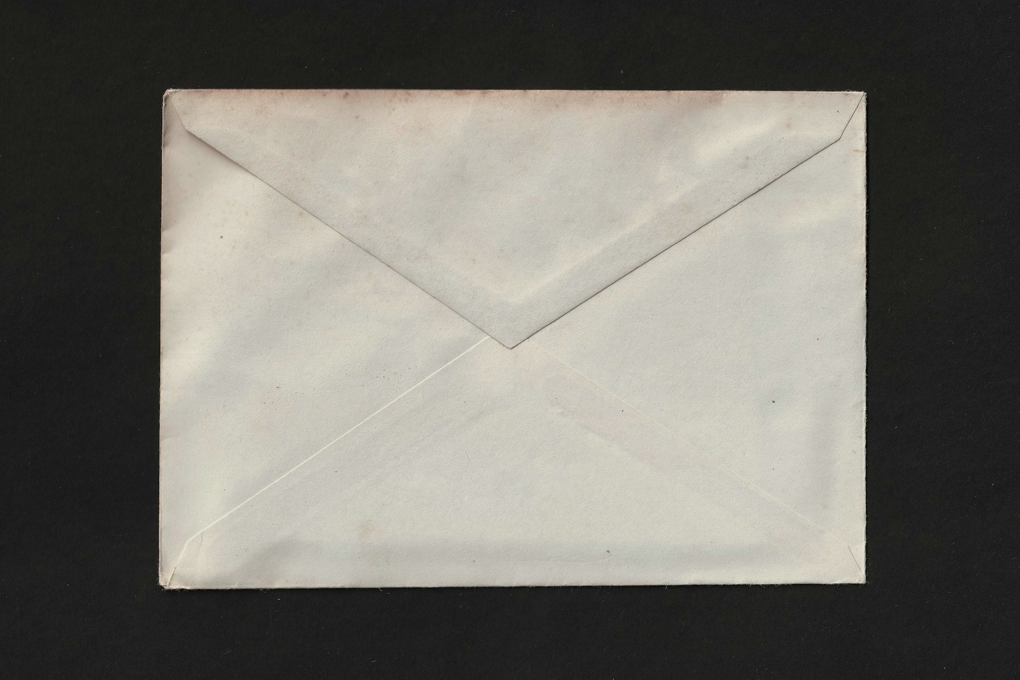 A plain envelope on a dark surface
