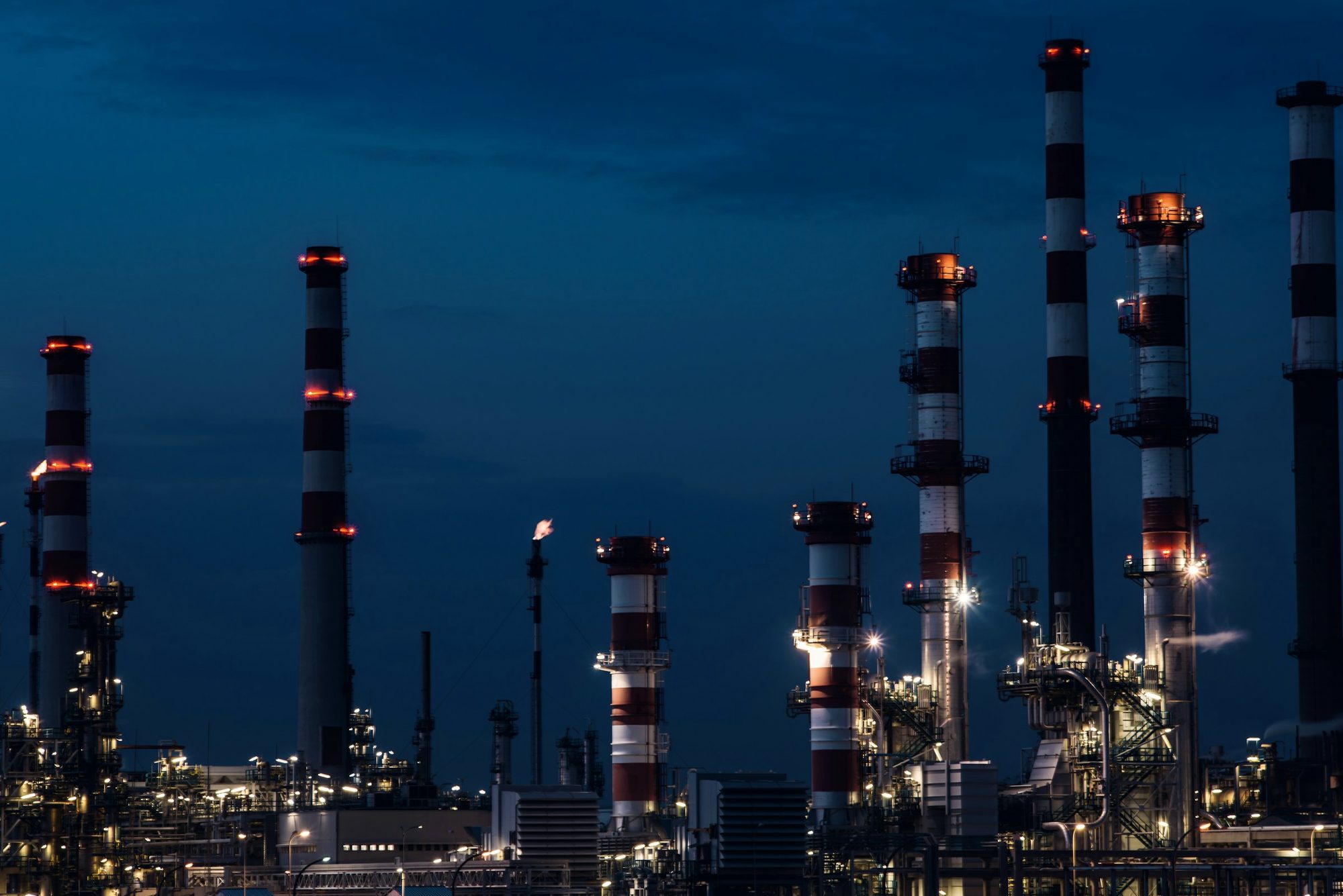 An industrial plant lit at night